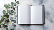 © CreativeCreations - blank white book cover mockup with eucalyptus branch minimalist flat lay