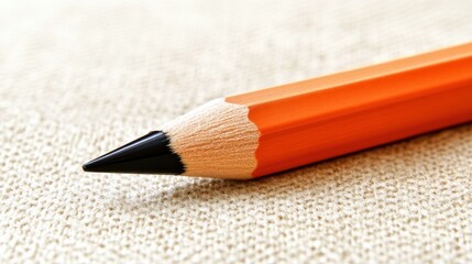 Poster - Close-up of a Sharpened Orange Pencil on a Textured Surface