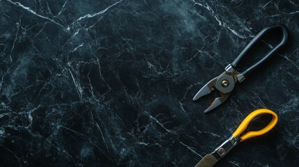 Electrician tools on black marble background, flat lay.