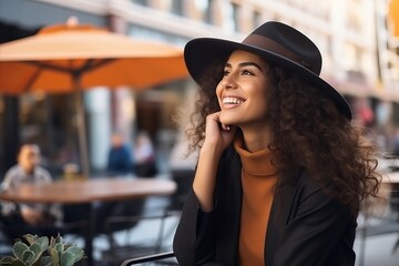 Portrait of a beautiful young african american woman with curly hair in a hat