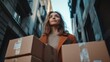 © Alexandr Efimov - A young woman with a focused expression, surrounded by boxes, suggests the hustle and bustle of urban delivery services. The cityscape in the background paints a picture of modern life.