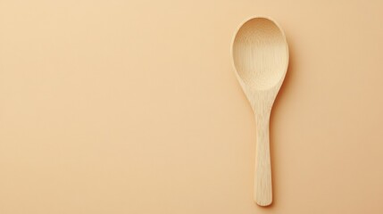 Wooden Spoon on a Beige Background