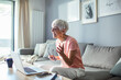 © Marko Geber - Senior woman working on laptop at home