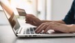 © RifaldiMuhammadSalim - hands using a laptop with a credit card, the process of making an online order