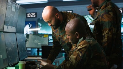 Poster - Military dispatcher helped by coworker with tablet to gain info from army intelligence analysts. Army intelligence corps expert discussing with colleague in command post, camera A