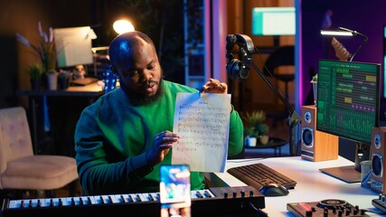 Poster - Skilled performer explaining sheet with musical notes on online video tutorial, internet lessons in home studio. Producer artist teaching how to read acoustical notation, playing piano. Camera A.