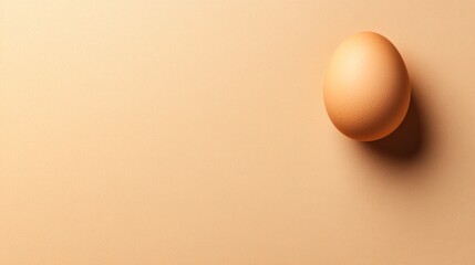 Poster - Single Brown Egg on a Light Orange Textured Surface