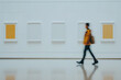 © HecoPhoto - Blurred Man Walking Past Gallery Wall with Yellow and White Artwork