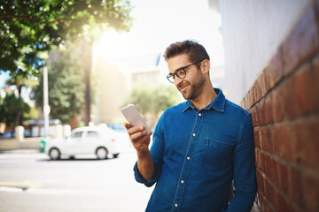 Poster - City, reading and man with smartphone for chat, communication and social media with online contact. Travel, male person and tourist with cellphone for application, connect and search location by wall