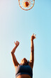 © peopleimages.com - Woman, sports and goal as basketball player as athlete on court for challenge as ready for training. Female person, blue sky and below for competition, match or game in physical activity or exercise