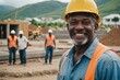 © ThomasLENNE - Close portrait of a smiling senior Saint Kitts and Nevis man construction worker looking at the camera, Saint Kitts and Nevis outdoors construction site blurred background