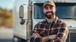 © Gophotograph - Young male truck driver proudly poses in front of his truck.