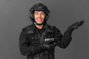 SWAT caucasian man isolated on grey background extending hands to the side for inviting to come