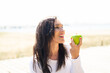 © luismolinero - Middle aged woman holding an apple with happy expression