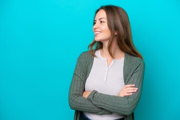 Young caucasian woman isolated on blue background happy and smiling