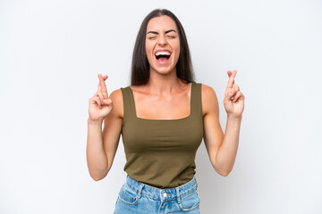 Young caucasian woman isolated on white background with fingers crossing