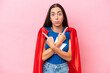 © luismolinero - Super Hero Caucasian woman isolated on pink background pointing to the laterals having doubts