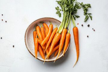 Bowl of fresh carrots with scattered leaves ? vibrant orange colors against a plain background.