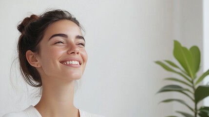 Woman with a big smile on her face. She has a lot of teeth and is looking at the camera