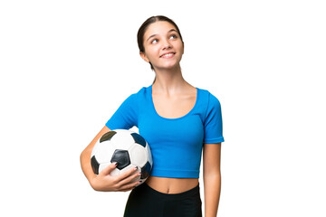 Poster - Teenager caucasian girl playing football over isolated background looking up while smiling