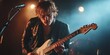© gen_pick - Rock guitarist performing on stage with lights and energy