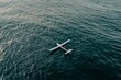 © Victor Bertrand - Solitary drone calmly sails over open ocean, embraced by serenity of the vast, rippling waters beneath the tranquil sky.