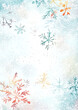 © Phuwadon - Colorful snowflakes against a soft, frosty background, creating a serene winter atmosphere.