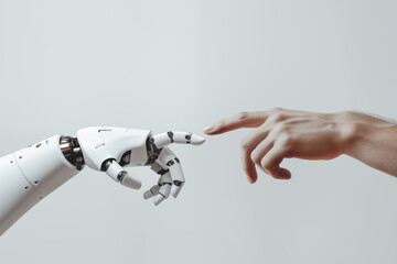 a white cyborg robotic hand with an extended finger pointing toward a human hand with an extended fi