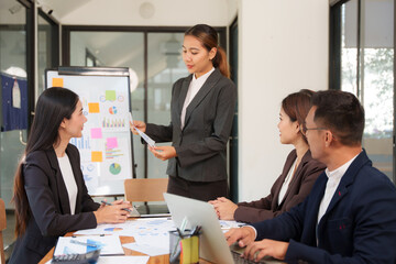 A group of Asian businessmen is Meeting to discuss presentations exchange knowledge Presentation about office work