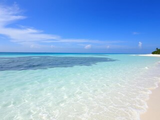 Clear blue waters of the ocean with gentle waves crashing against the sandy beach under a clear sky, tropical, vacation