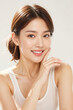 © KayKai - A woman with a white tank top is smiling and making a face
