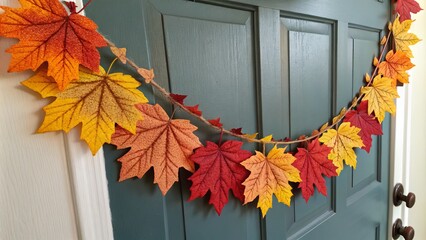 Vibrant fall leaves create a beautiful garland decor on a door, adding warmth and color to autumn-themed spaces.