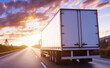 © Curioso.Photography - A large white truck drives down an empty highway at sunset, symbolizing freight transportation and long-haul trucking.