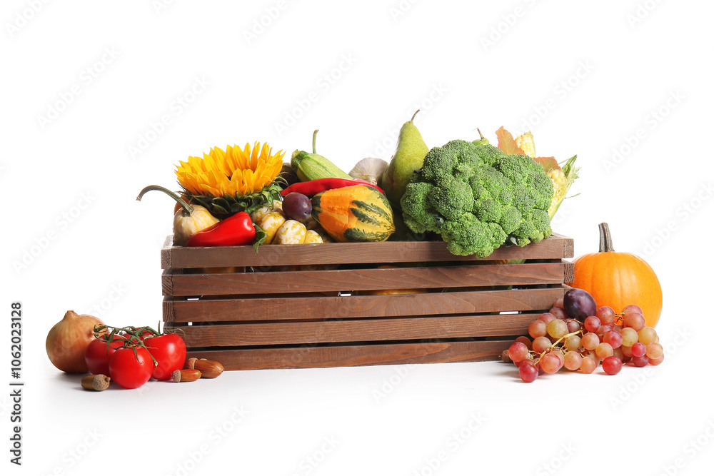 Wooden box with different fresh vegetables, fruits and sunflower on white background. Harvest festival