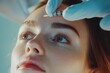 © JAYDESIGNZ - Closeup shot of young Caucasian woman getting beauty cosmetic injection in forehead, beautiful lady getting anti-aging treatment