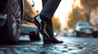 © Prasanth - close up of man wearing black shoes stepping out from luxury car, business suit, blurry background, car on the left side of frame,