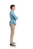 Fototapeta Panele - casual young man standing in line with arms crossed confidently