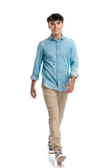 happy young student in his 20s walking and smiling