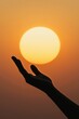© Amara - Hopeful Serenity Silhouette of Hand Reaching for Sun in Warm Sunset Sky