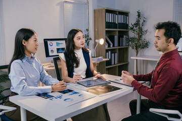Fototapete - Business team discussing and brainstorming, analyzing sales data chart using tablet and computer in the meeting room, during a corporate meeting