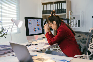 Poster - Young asian businesswoman is having a bad headache and feeling tired from working on a laptop for a long time, she is exhausted and stressed from work