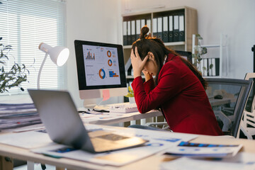 Poster - Young business woman is working with a lot of stress and headache from working in the office using a computer and laptop