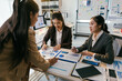 © PaeGAG - Three asian businesswomen are having a meeting in a modern office, analyzing financial charts and discussing business strategies