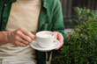 © RooM The Agency - Close-up of a Man sitting at an outdoor cafe drinking a cappuccino