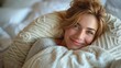 © Miodrag - Smiling woman hugging a cozy pillow while relaxing in a comfortable bedroom setting