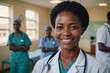 © ThomasLENNE - Close portrait of a smiling young Zambian woman doctor looking at the camera, Zambian hospital blurred background