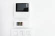 © Home-stock - Empty display of modern intercom, air conditioning control panel and light switches on white wall, free copy space