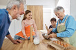 © Lumos sp - grandchild family child grandparent grandfather together grandmother cooking kitchen food baking preparation homemade dough ingredient flour making cake kneading pastry cook