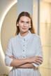 © Евгений Вершинин - An Elegant Woman in a Stunning White Dress Posing Gracefully in a Modern Artistic Space