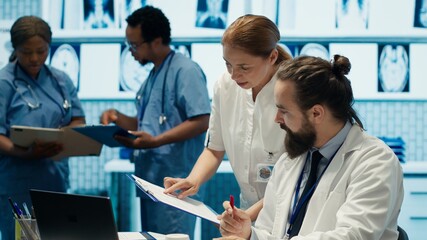 healthcare professionals examine human anatomy scans to develop treatment plans, teamwork and expert